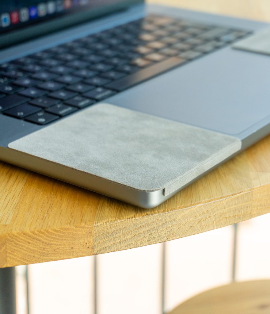 ChronoPad palm rest protector on a MacBook on a round wooden table